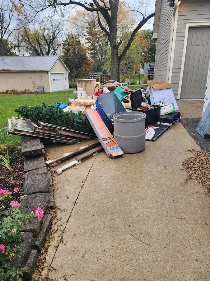 Dumpster being loaded with debris for Estate Cleanout Dumpster Rental in Stacy
